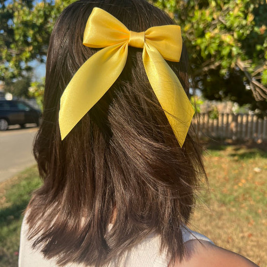 Woman wearing yellow Satin Small Hair Bow with Tails