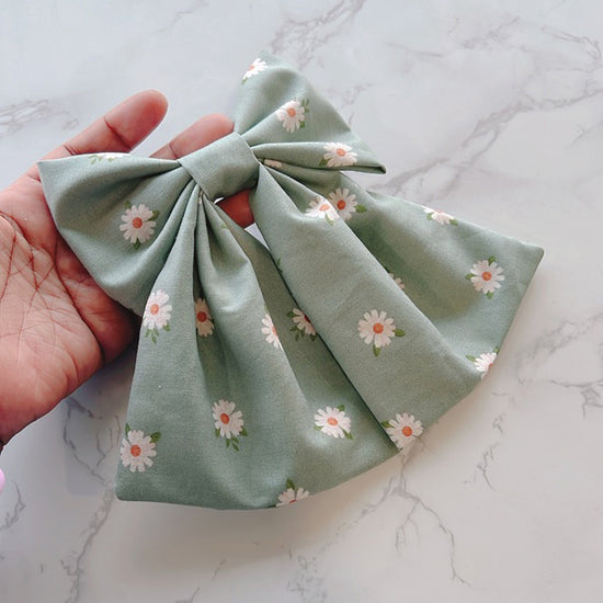 Hand holding Flower Garden Bow
