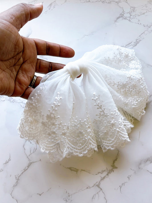 Hand holding Flow Lace Bow