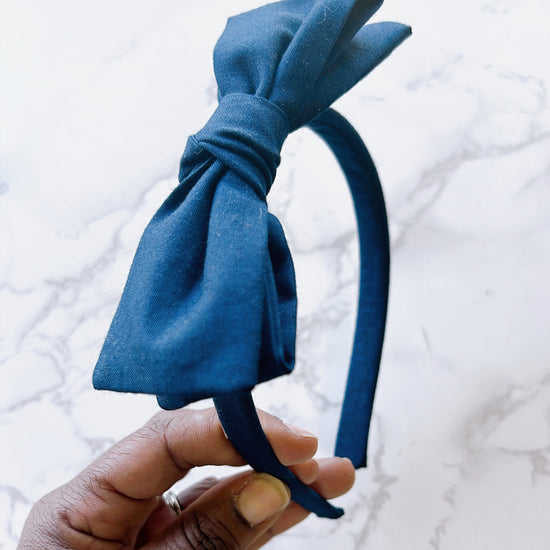 Navy hard headband with a hand tied bow