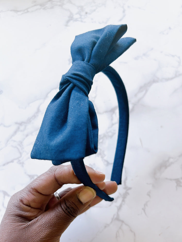 Navy hard headband with a hand tied bow