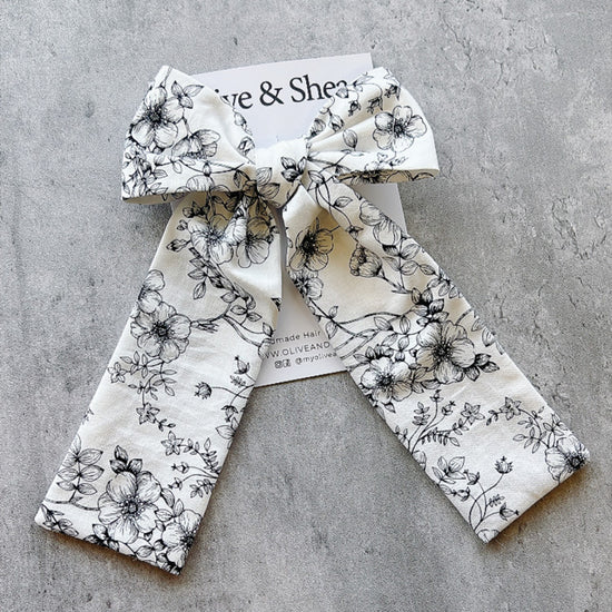 Handmade hair bow with black floral pattern