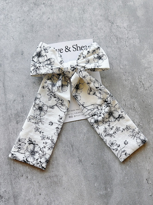 Handmade hair bow with black floral pattern