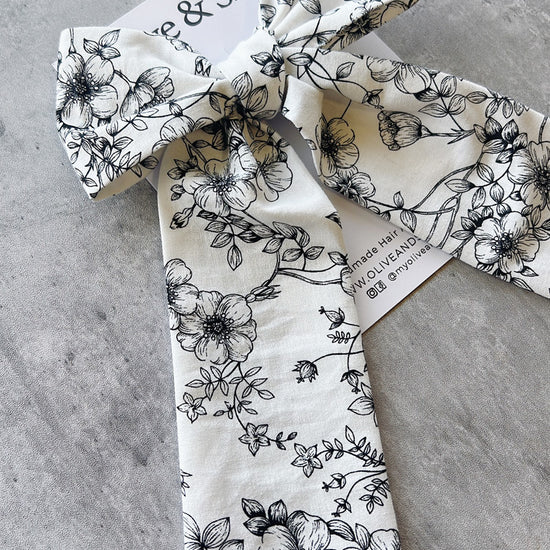 Handmade hair bow with black floral pattern