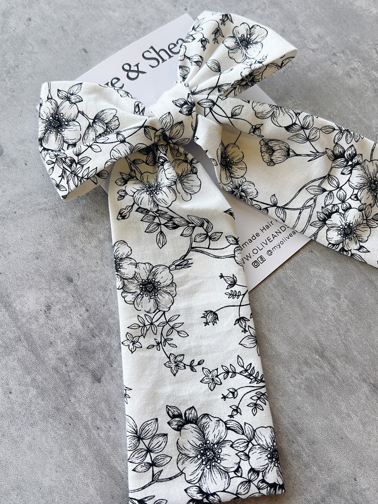 Handmade hair bow with black floral pattern