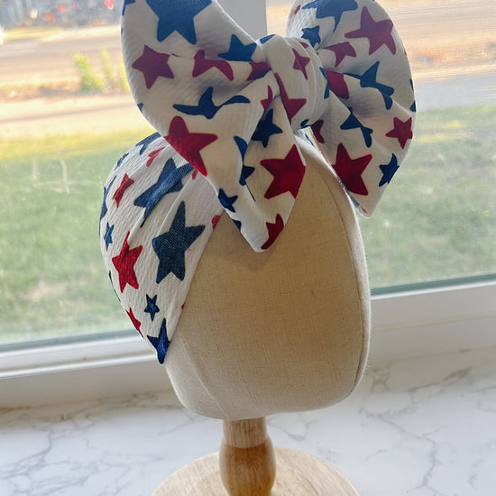Baby Bow headband with red, white, and blue star pattern 