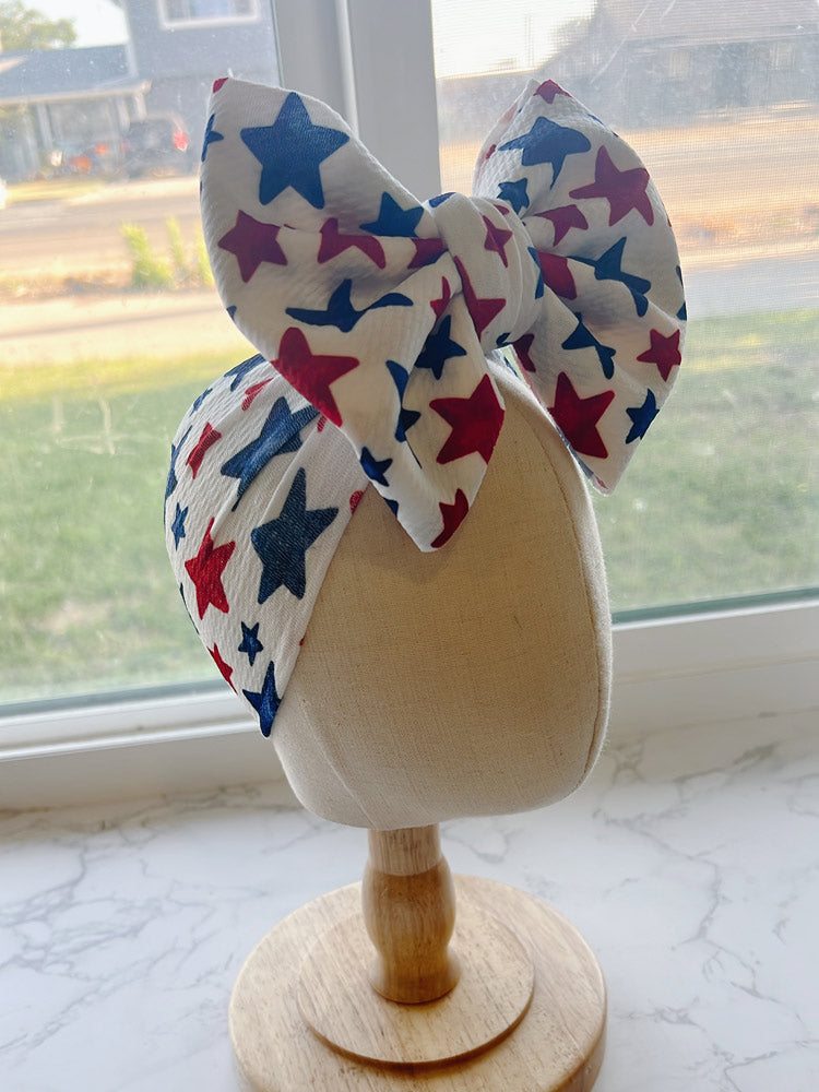 Baby Bow headband with red, white, and blue star pattern 