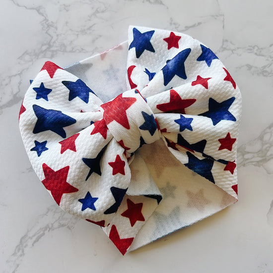 Baby Bow headband with red, white, and blue star pattern 