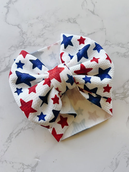 Baby Bow headband with red, white, and blue star pattern 